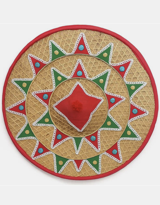 Circular woven bamboo wall hanging with red and green geometric fabric trims